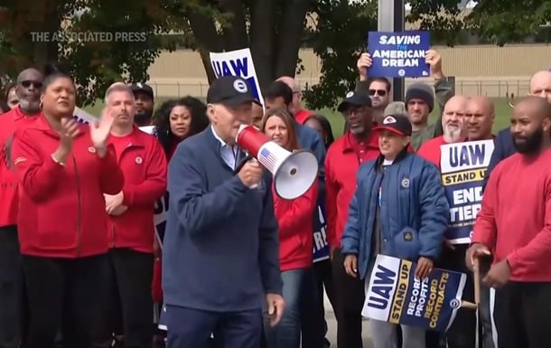 Biden urges striking auto workers to ‘stick with it’ in picket line visit unparalleled in history