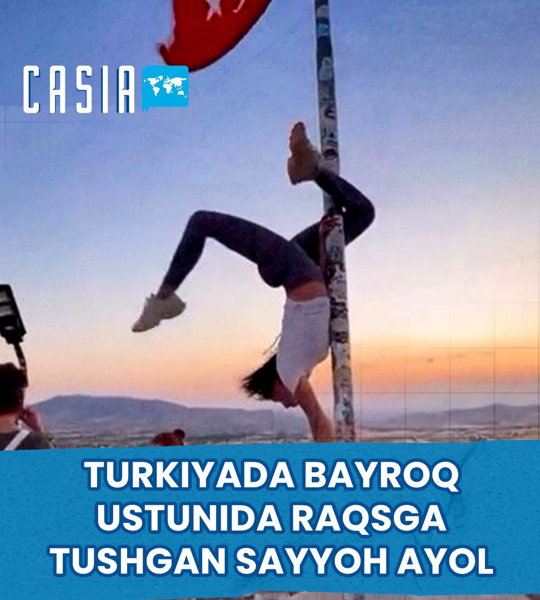 A tourist woman dancing on a flagpole in Turkey